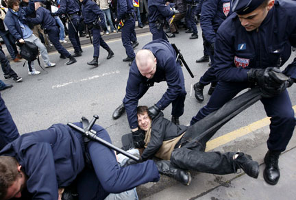 La police maîtrise un manifestant lors du parcours de la flamme olympique.(Photo : Reuters)